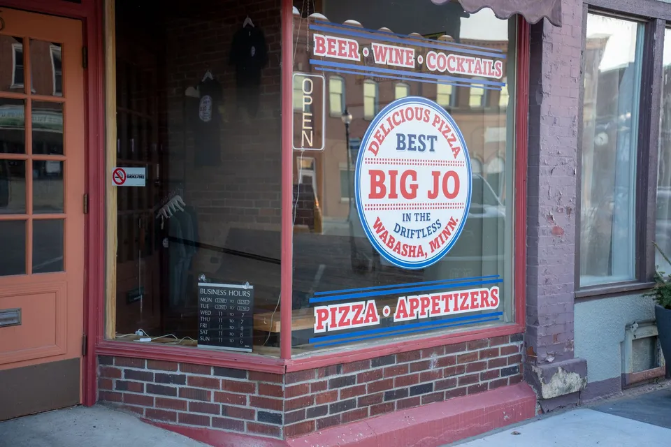 Charming storefront of Big Jo's Pizza in Wabasha, MN, displaying beer, wine, and appetizers.